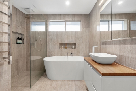 Sandringham-Main bathroom.  Heated floor and towel rail. Maximising the space with a large stand alone bath. Whilst the wall hung vanity creates a sense of space. The large frameless panel disappears allowing the room to remain spacious