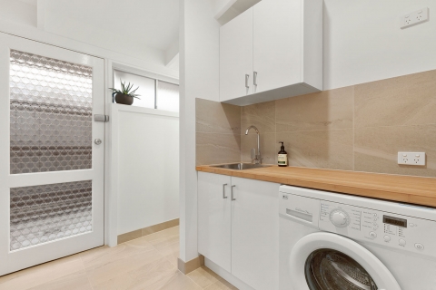 Cheltenham-Laundry and powder room. An additional toilet was added to give the home 2 toilets. Using the same tiles s the bathroom tied the wet areas together.